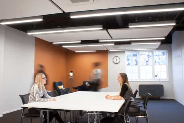Modern meeting room with large table, ideal for brainstorming and client meetings.