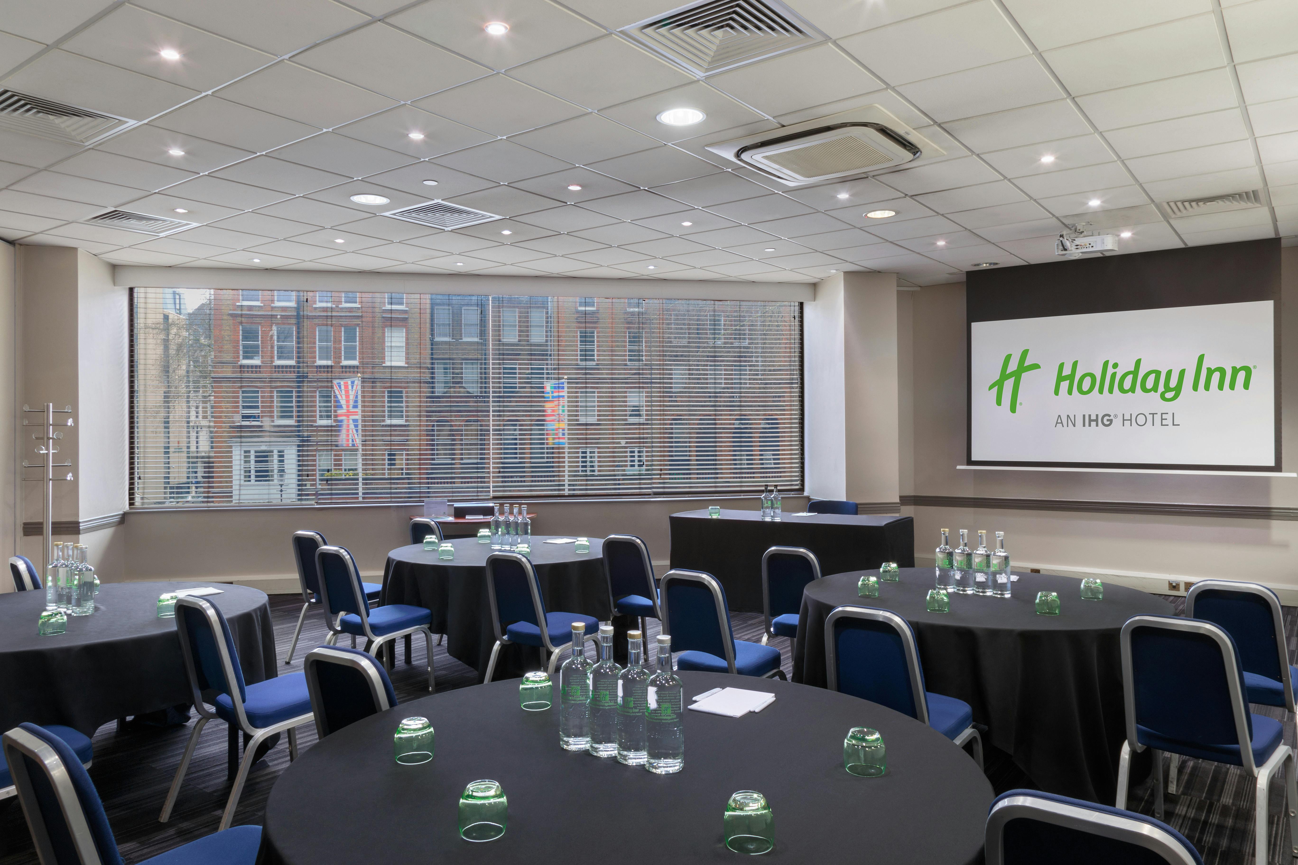 Madonna in a well-lit meeting room at Holiday Inn, perfect for corporate events.