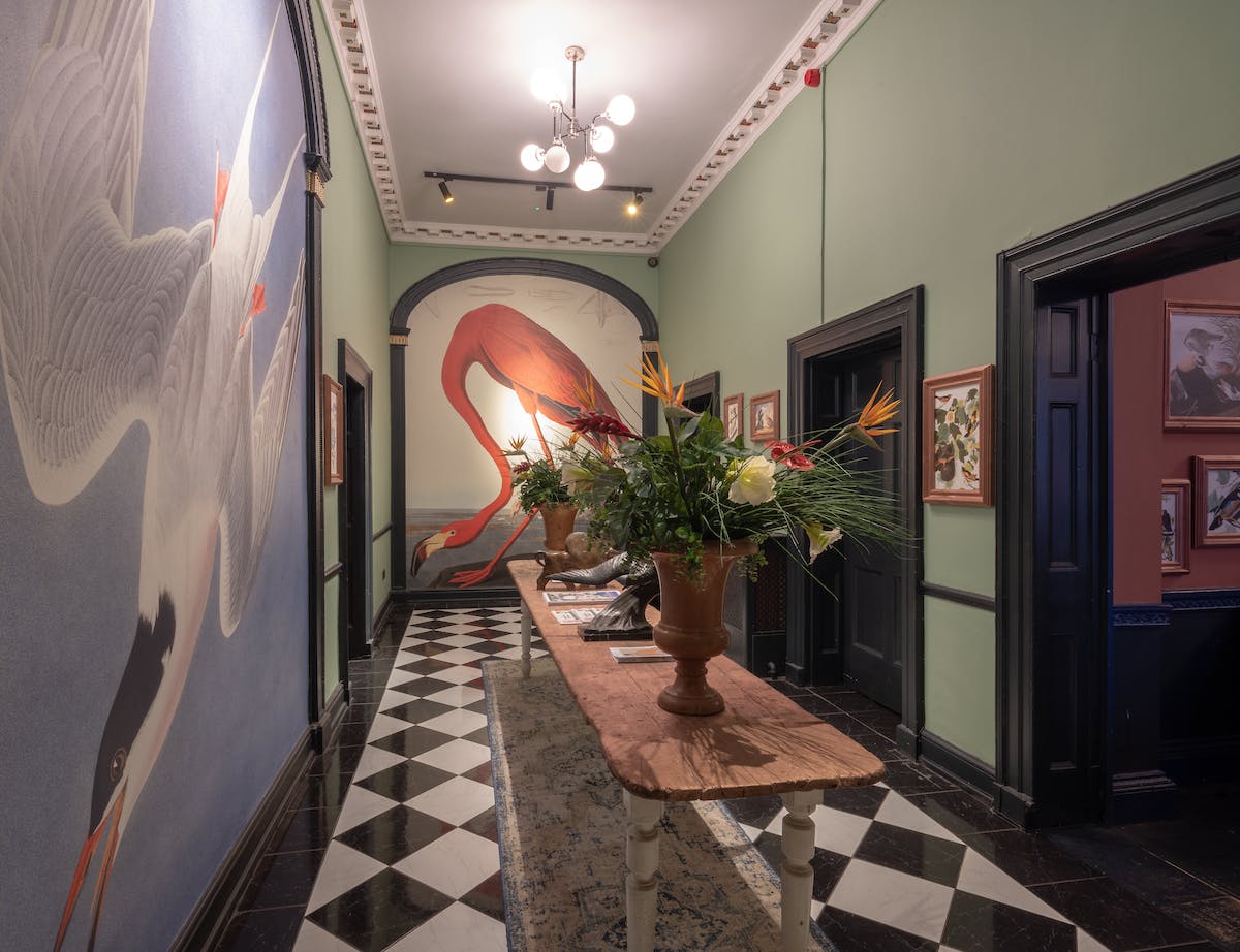 Stylish corridor with vibrant wall art for event registration and networking at Royal Institution.