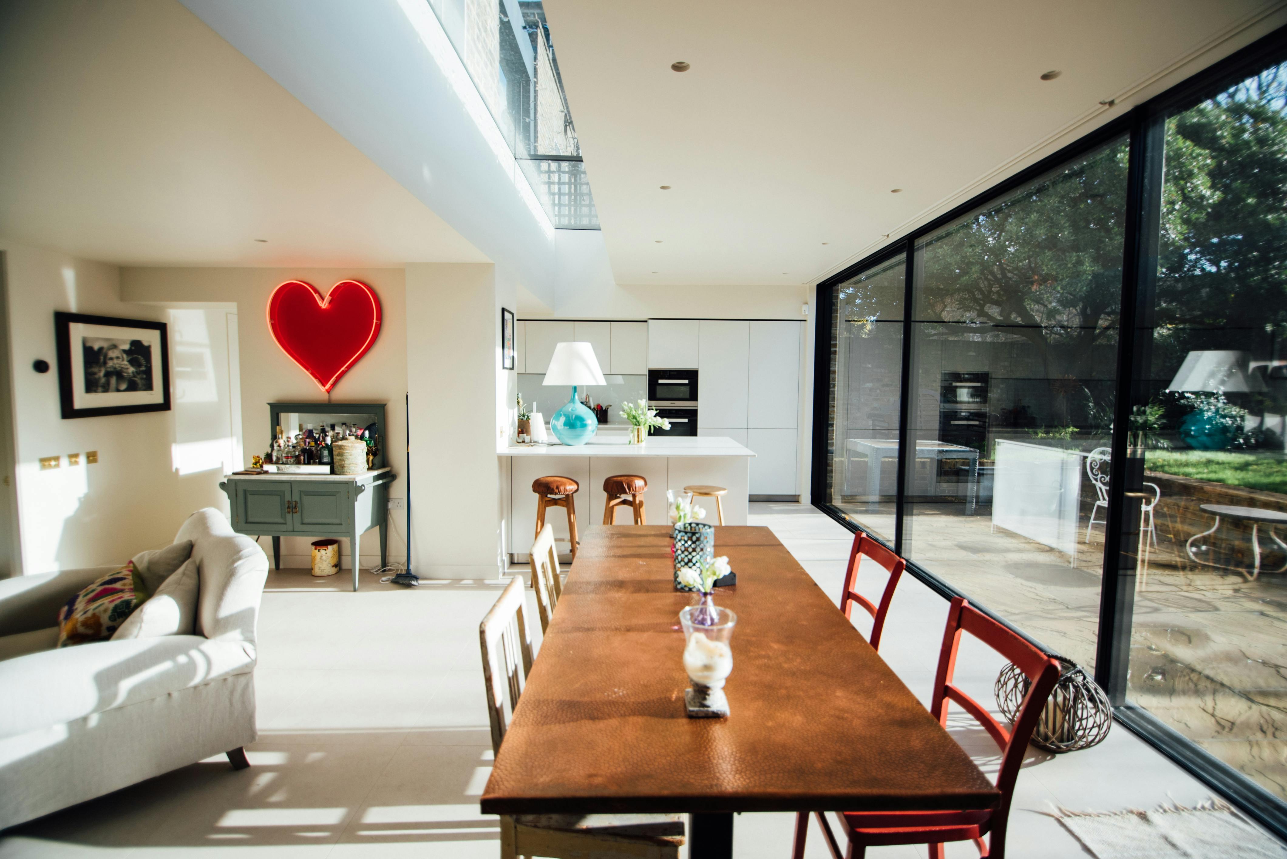 Modern event space in Northchurch Terrace with rustic table and colorful chairs.