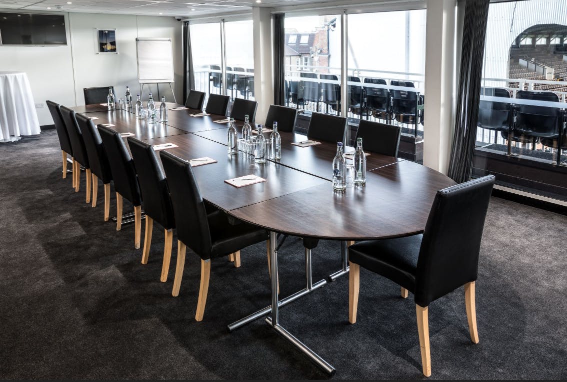 Superbox meeting room at Fulham FC with oval table, ideal for corporate events.