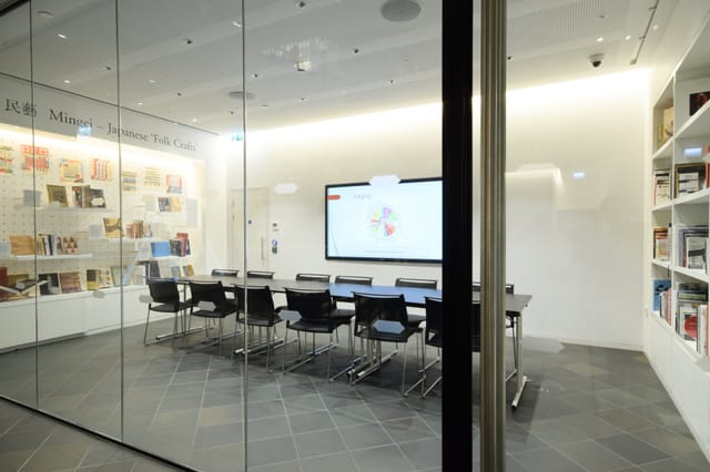 Modern meeting room in Japan House with glass walls, ideal for workshops and presentations.