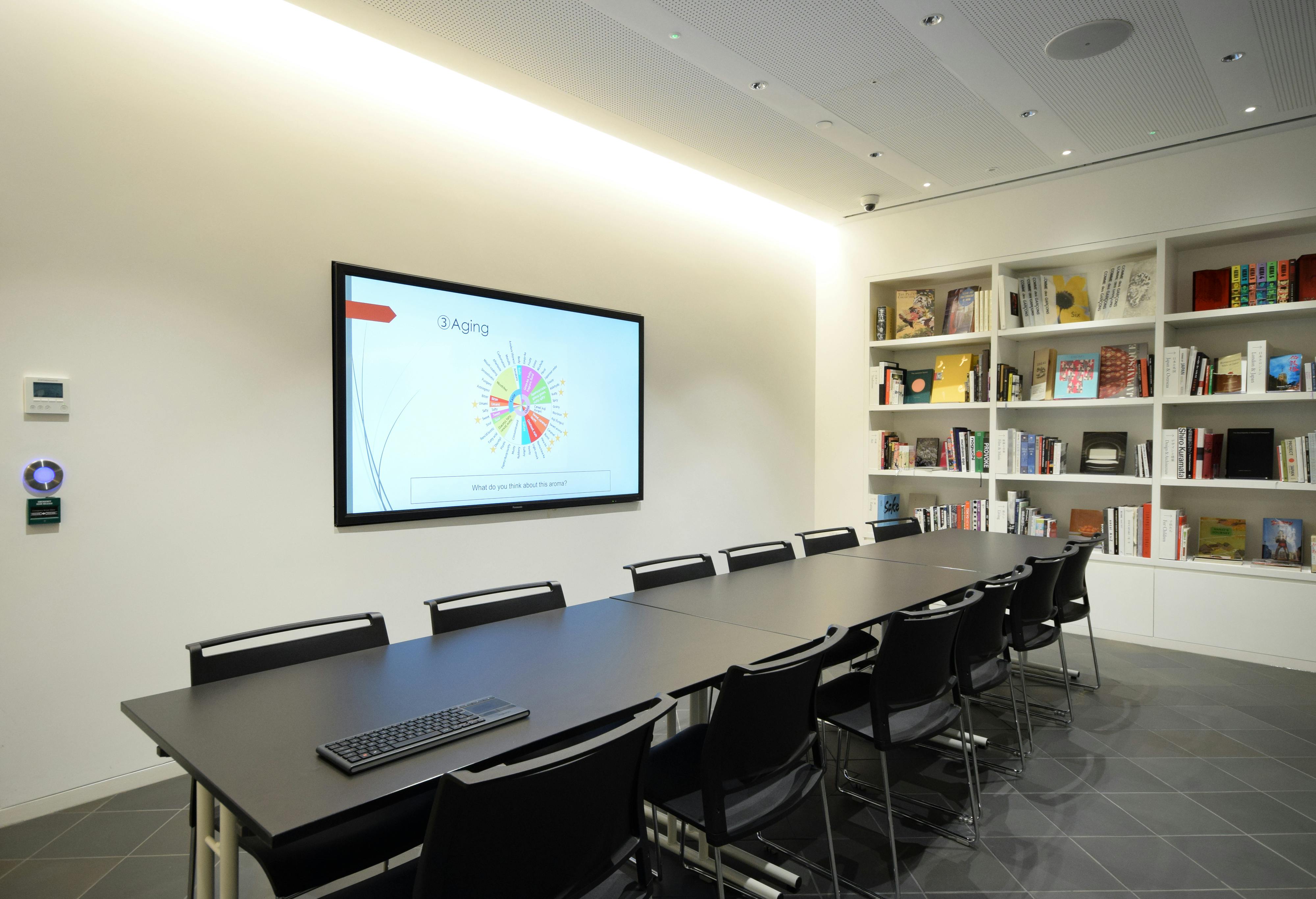 Modern meeting room in Japan House with large screen for collaborative presentations.