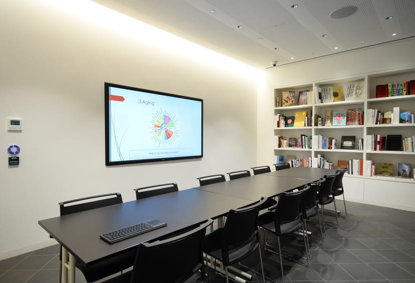 Modern meeting room in Japan House with large screen for collaborative presentations.