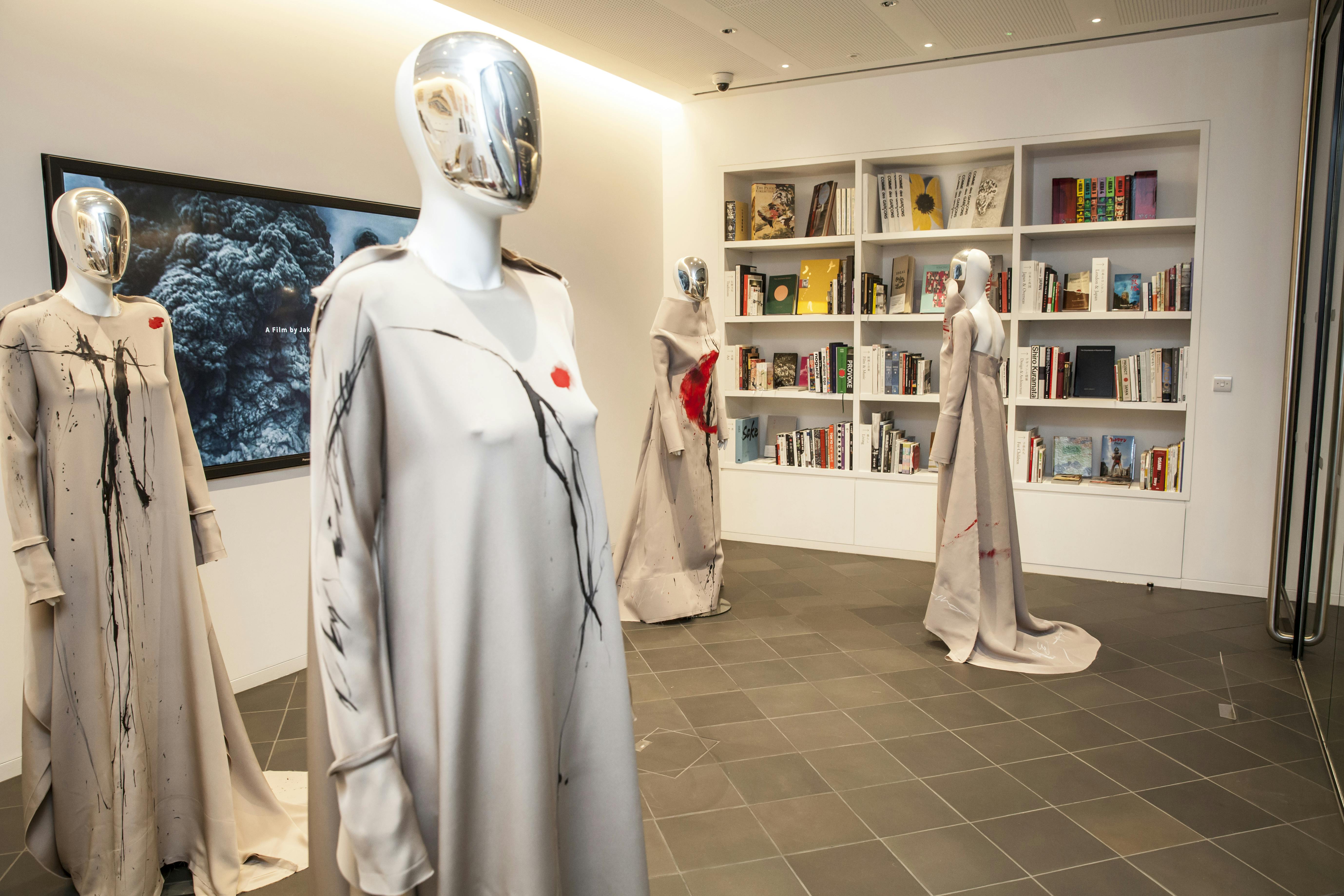 Contemporary library in Japan House with avant-garde mannequins for fashion events.