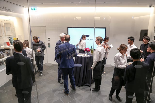Networking event in Japan House library with sleek design and engaged attendees.