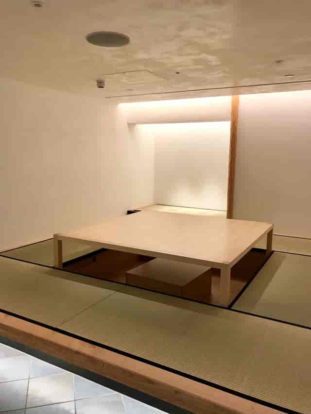 Tatami Room in Japan House: minimalist meeting space with low wooden table for workshops.