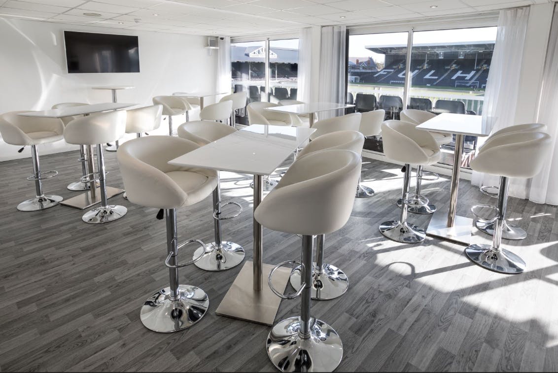 Modern Gin Bar at Fulham FC, featuring high-top tables for cocktail receptions.