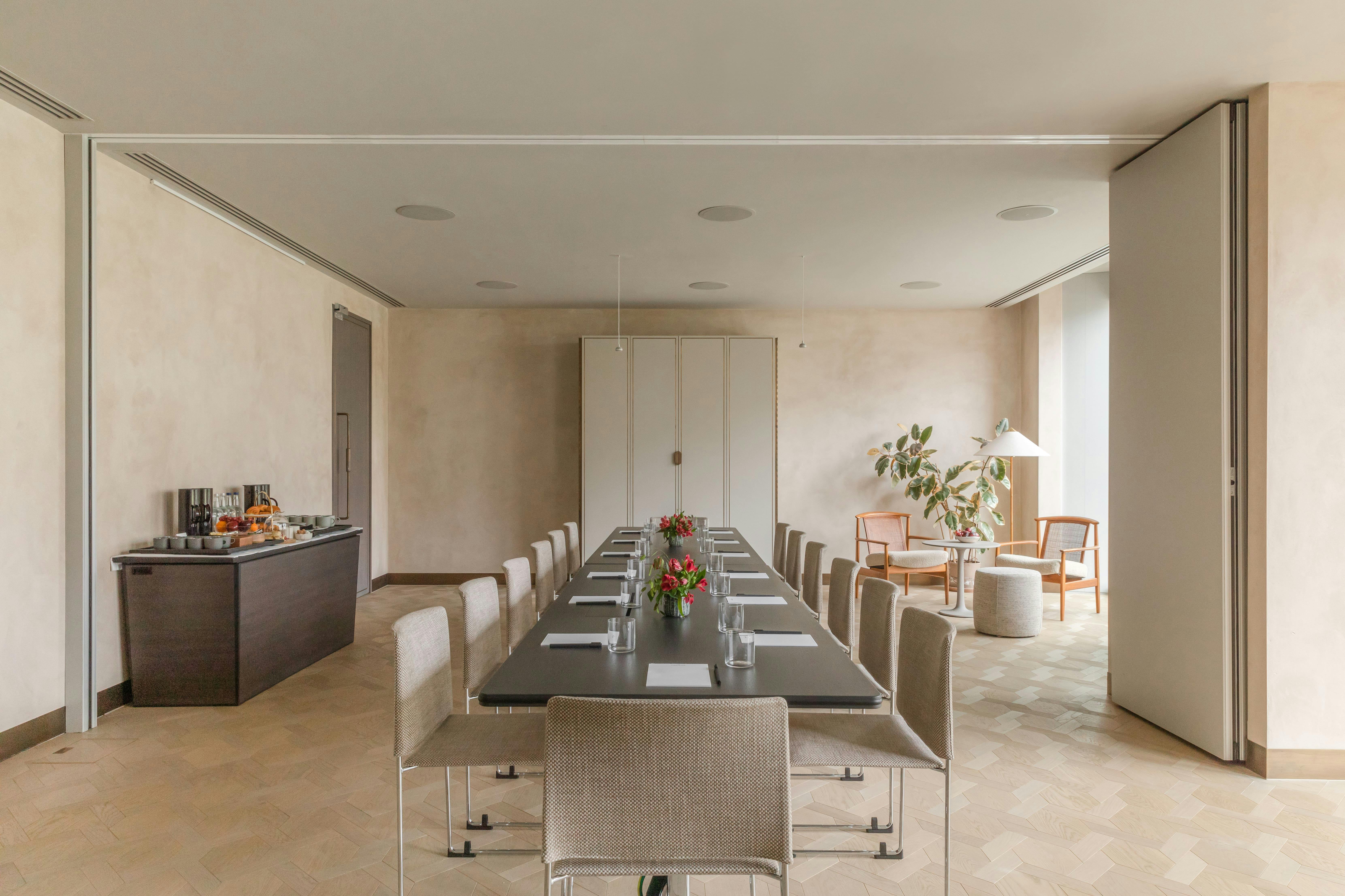 Modern meeting room at The Stratford, featuring a long table for professional gatherings.