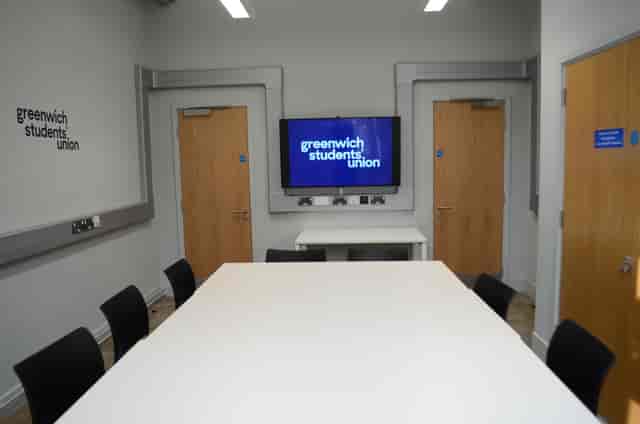 Modern meeting room with large table at Greenwich Students' Union for collaborative events.