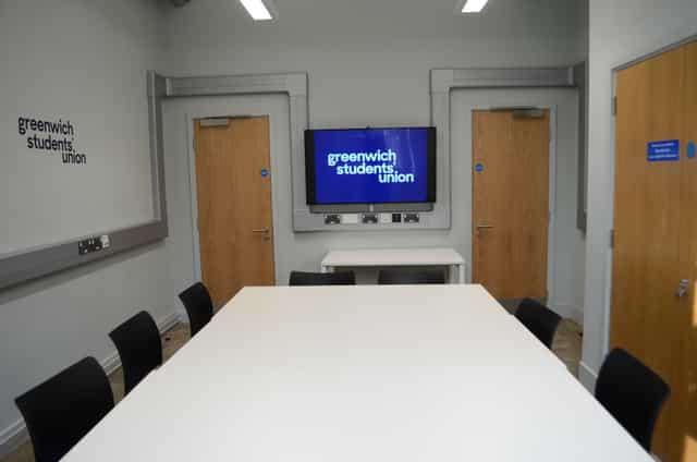 Modern meeting room with large table at Greenwich Students' Union for collaborative events.