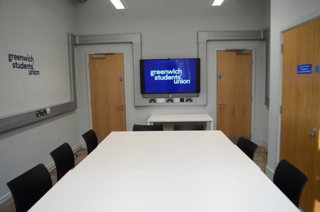 Modern meeting room with large table at Greenwich Students' Union for collaborative events.