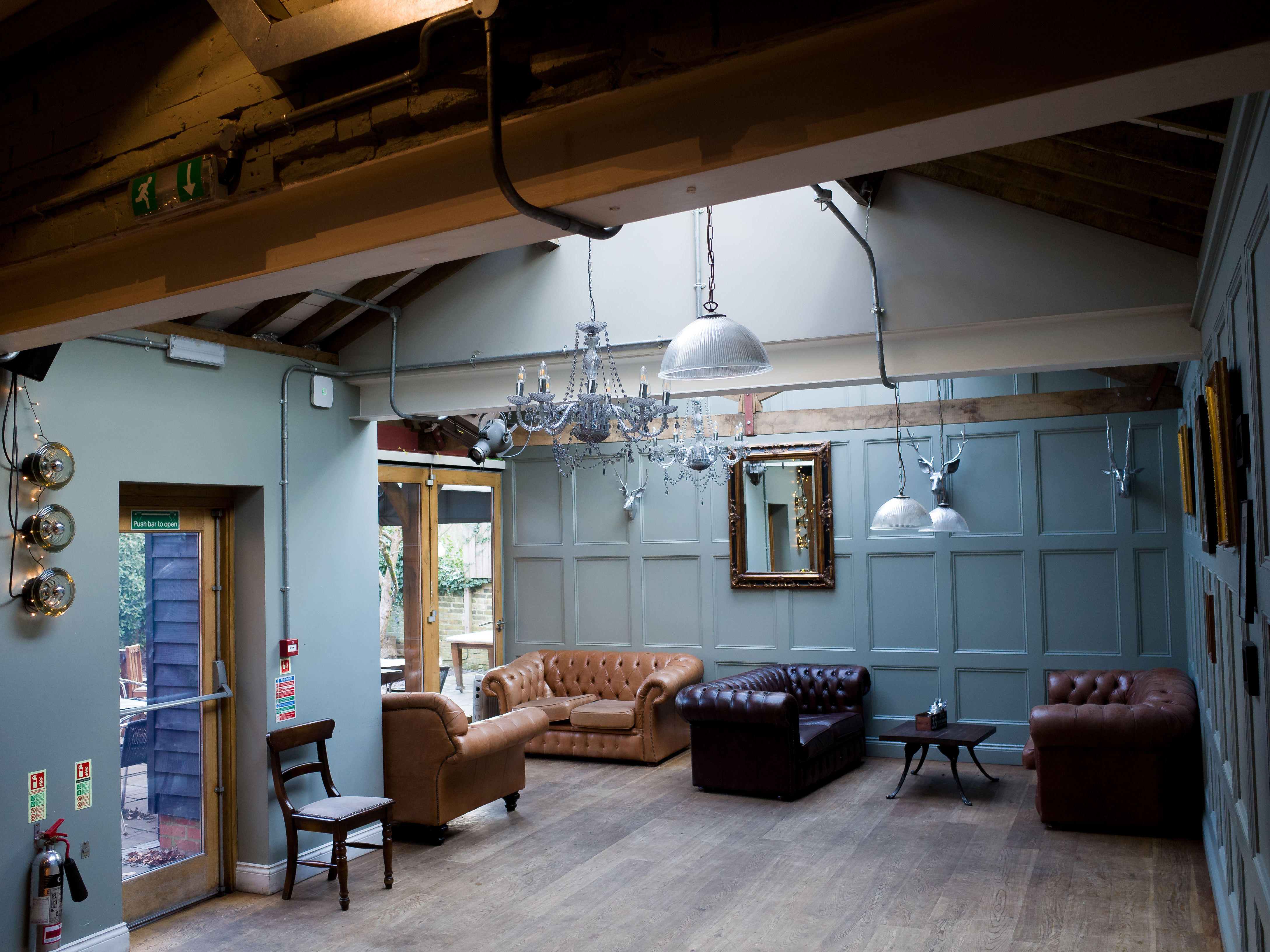 Stylish event space with leather sofas, ideal for workshops and gatherings at Adam & Eve. - Banner