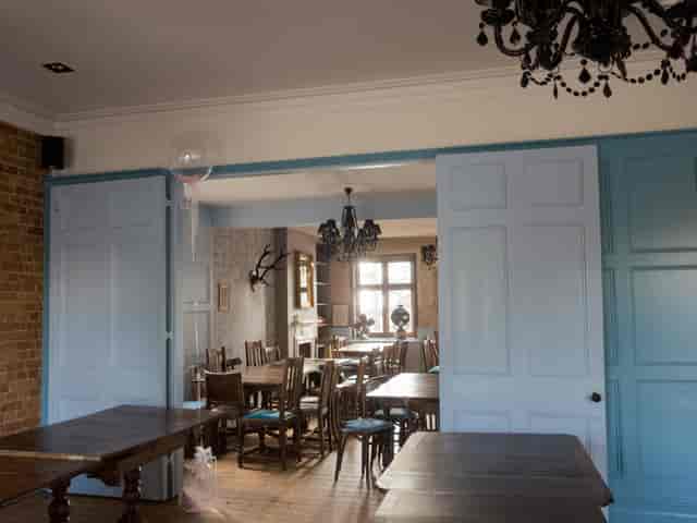 Function Room at Adam & Eve: rustic event space with elegant chandelier for gatherings.