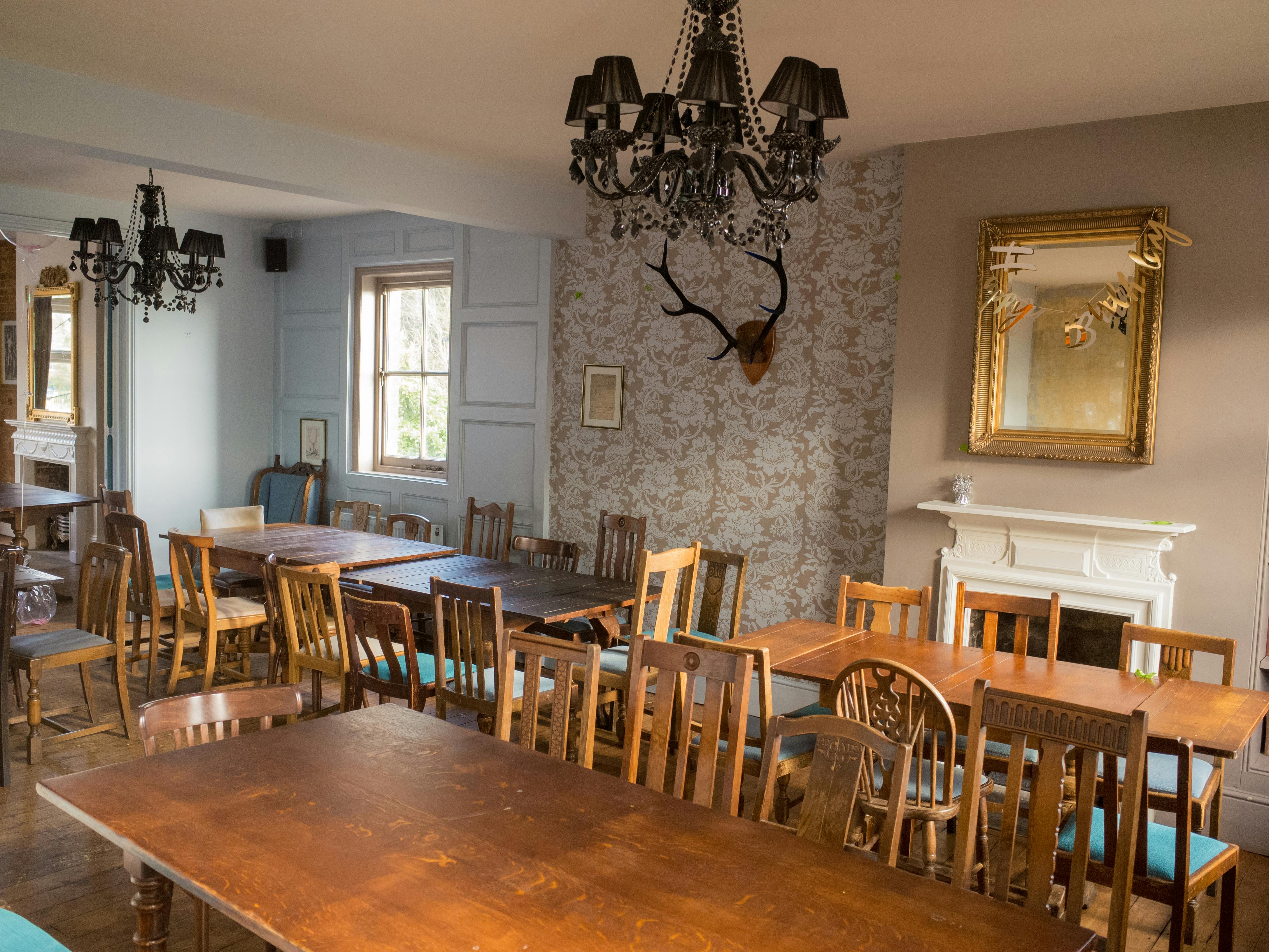 Charming event space with wooden tables, ideal for gatherings at Adam & Eve.