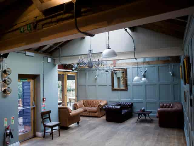 Stylish meeting space with leather sofas for creative gatherings at Adam & Eve.
