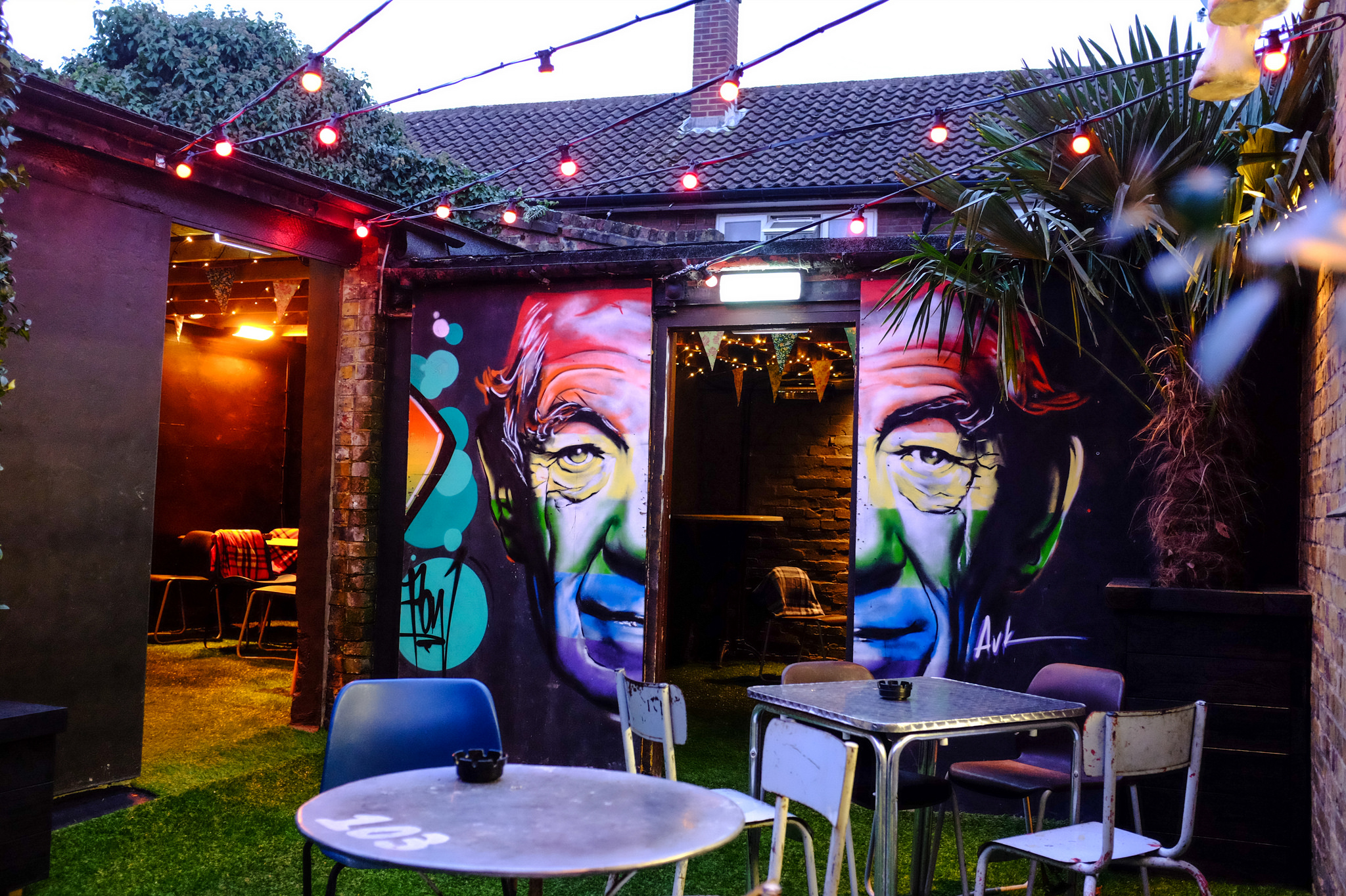 Semi-private garden at Ladywell Tavern with mural art for vibrant outdoor events. - Banner