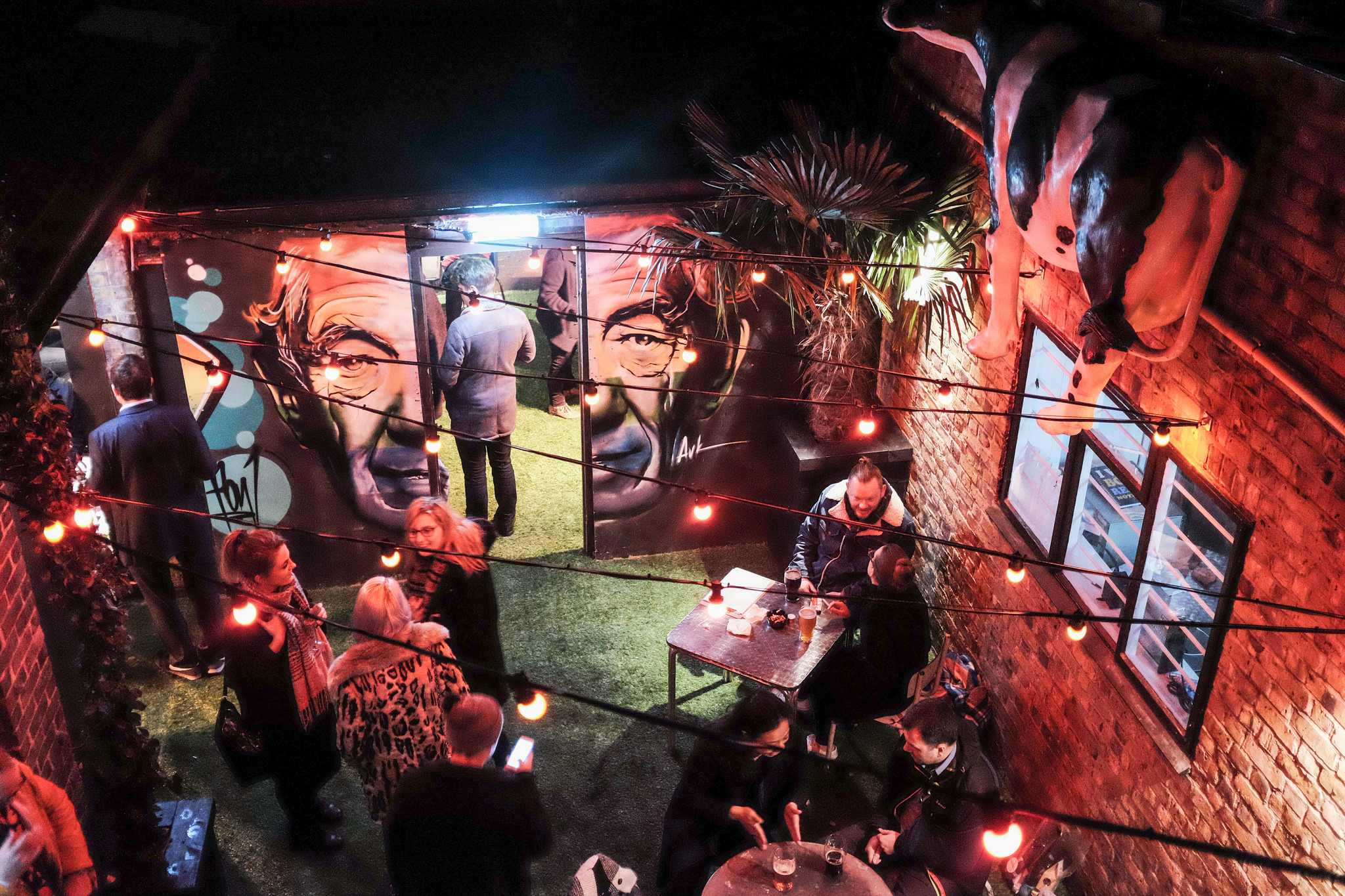 Semi-private garden at Ladywell Tavern with murals, ideal for social gatherings and events. - Banner