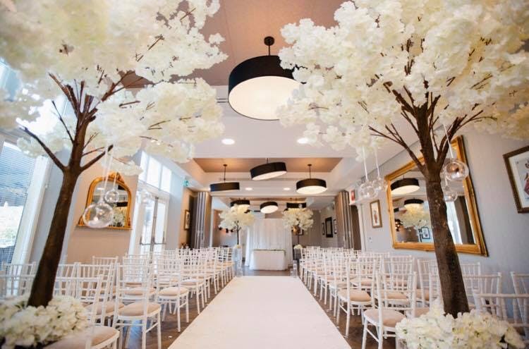 Elegant event space with floral decor, ideal for weddings and formal gatherings.