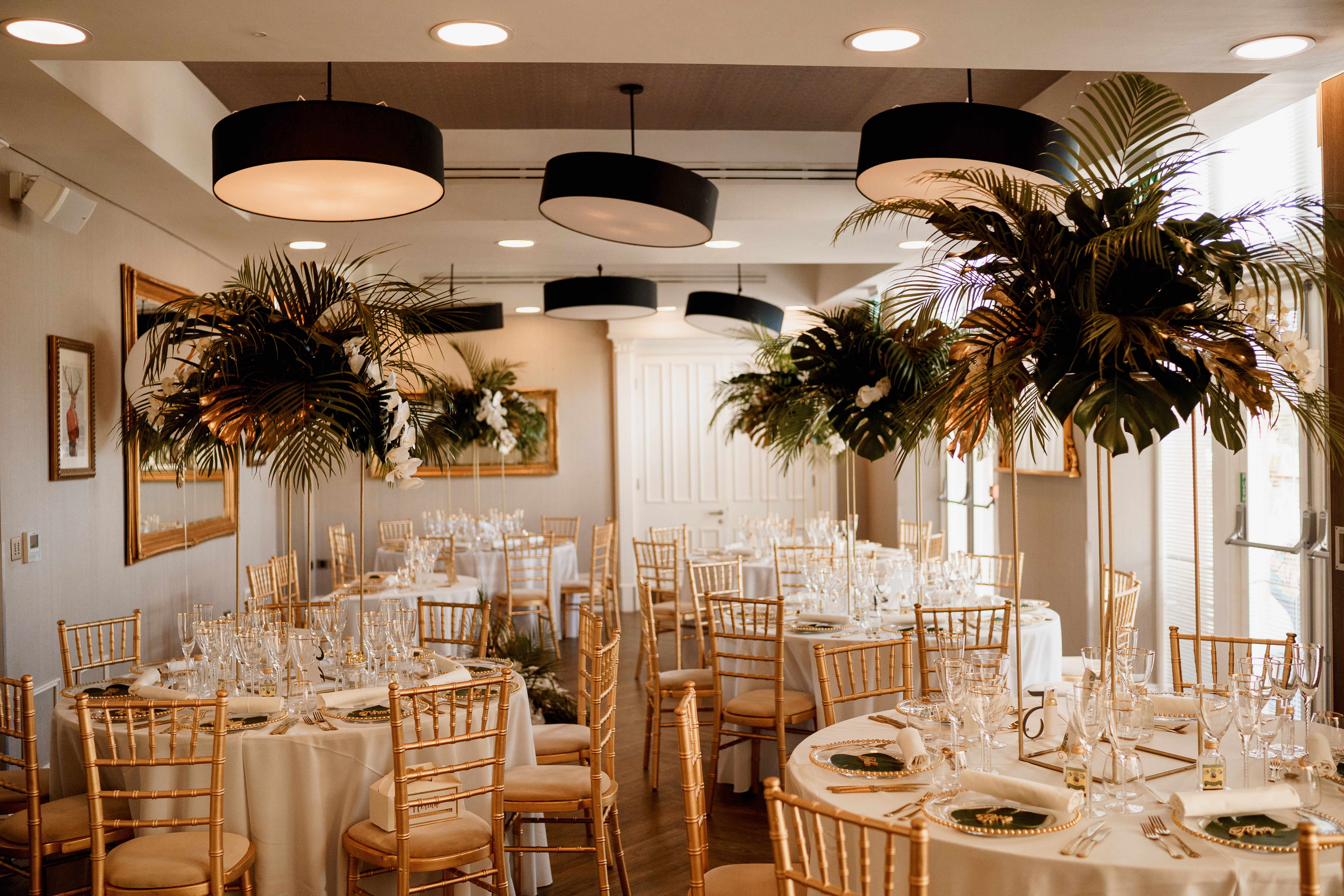 Elegant event space with round tables, white linens, and greenery at Oddfellows On The Park.