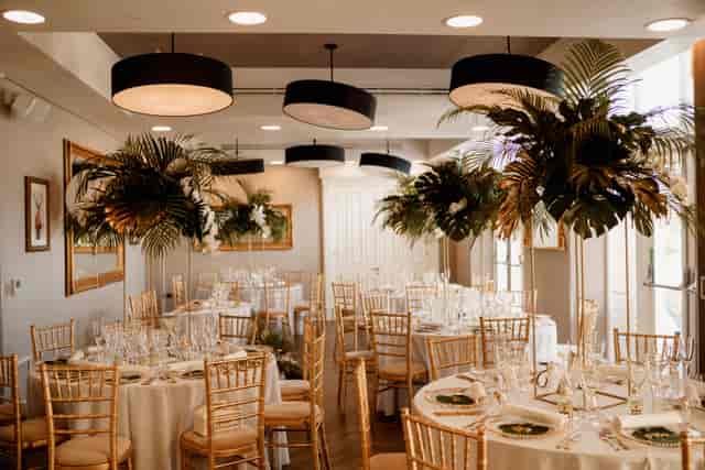 Elegant event space with round tables, white linens, and greenery at Oddfellows On The Park.