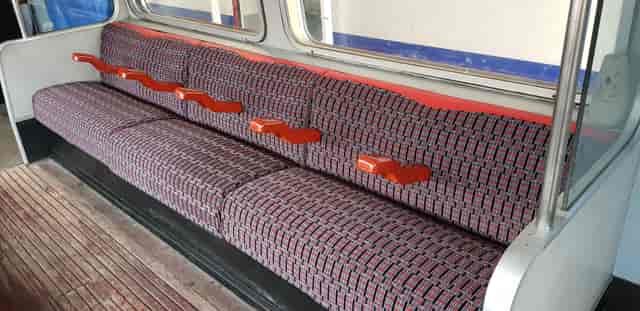 1967 Tube stock carriage seats with patterned upholstery at Walthamstow Museum event venue.