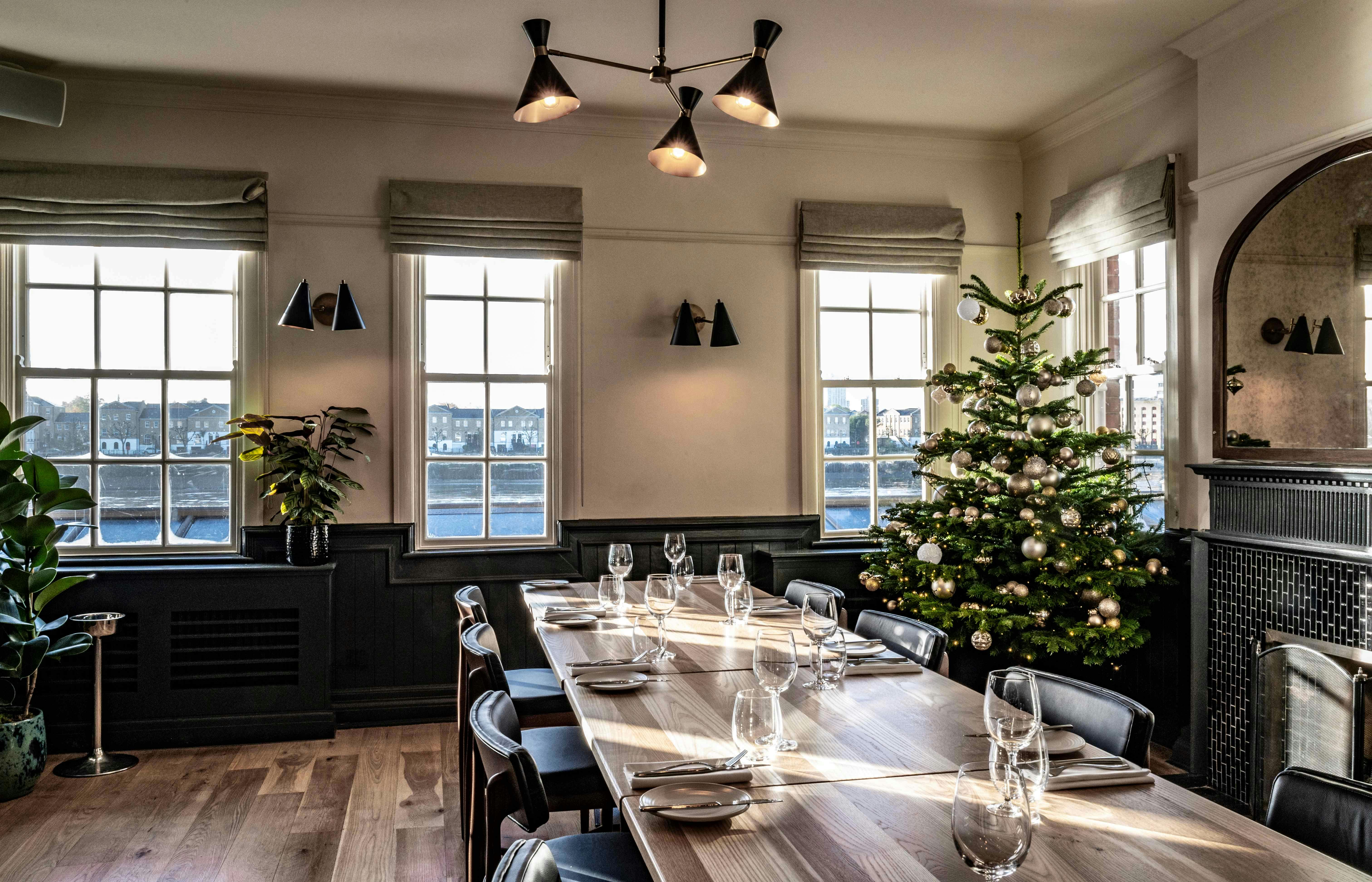 River Room at Bread Street Kitchen, elegant meeting space with festive decor for corporate events.