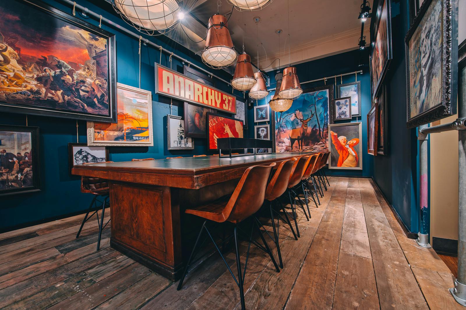 Unique meeting space in Glasgow with wooden table and eclectic artwork for events.