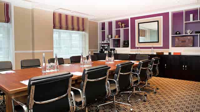 Victoria Suite at St Ermin’s Hotel, elegant meeting room with wooden table, ideal for conferences.