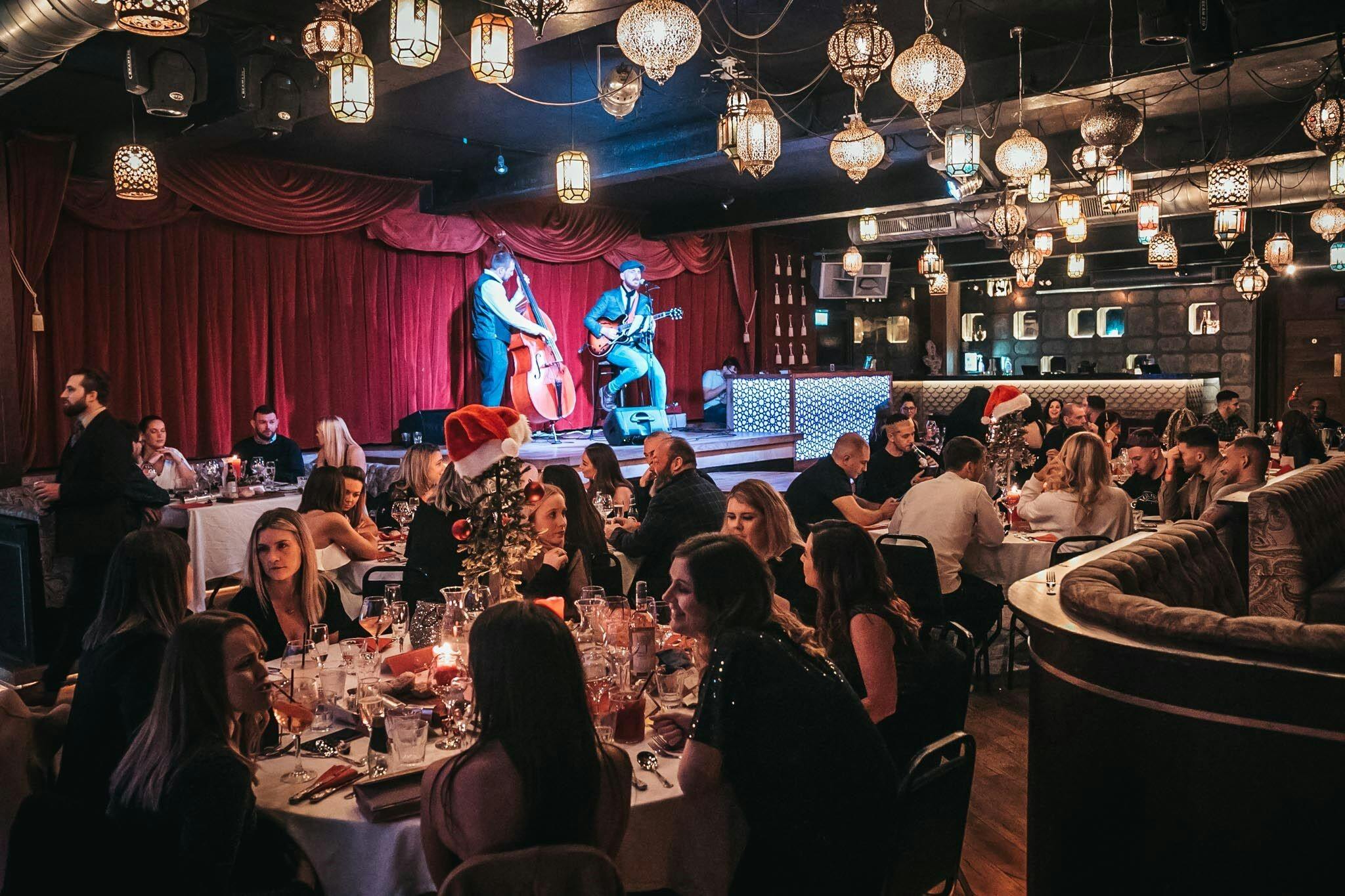 Vibrant Impossible Theatre event space with live performers for corporate events and parties.