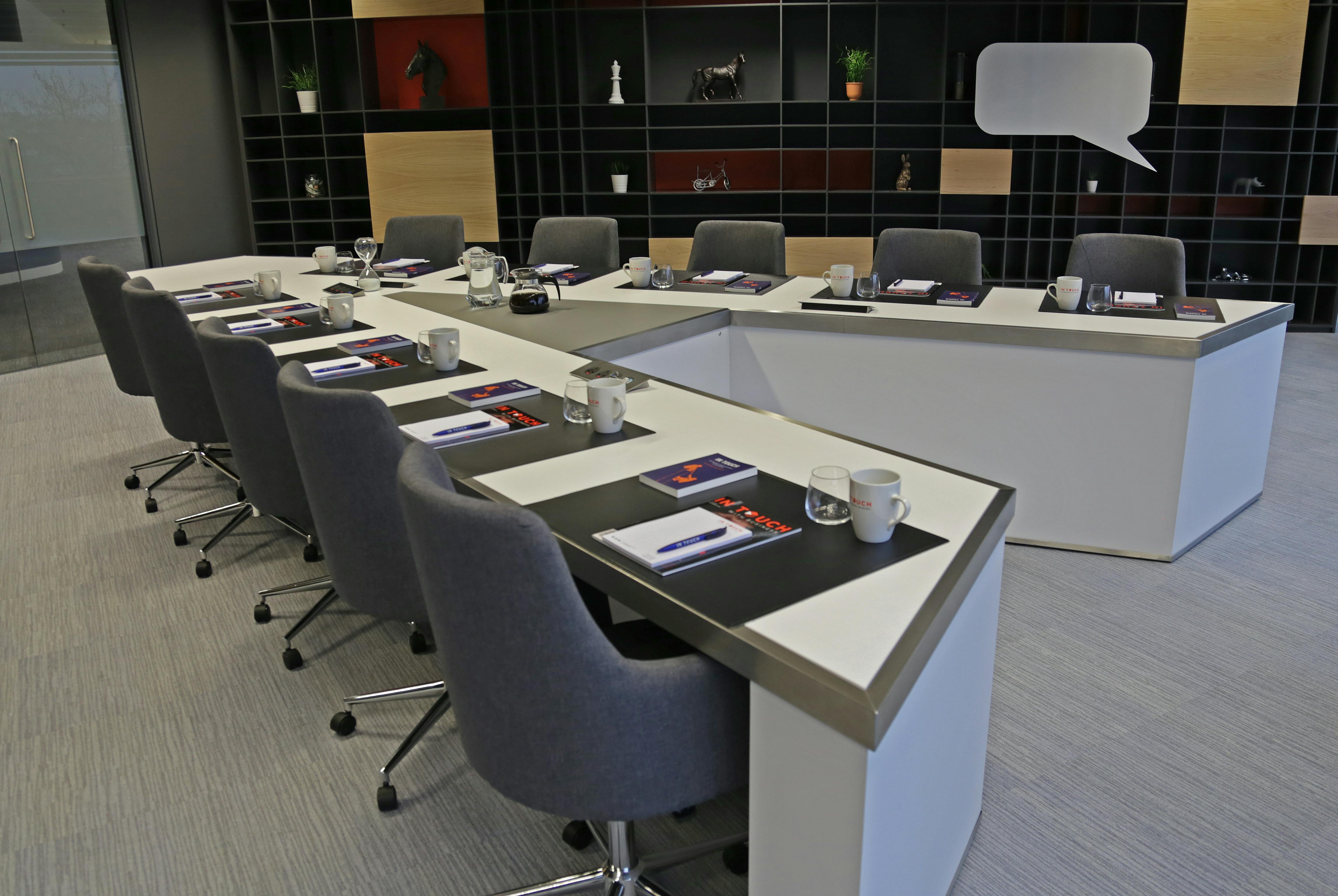 Modern meeting room with U-shaped table at Manchester Conference Centre for workshops.