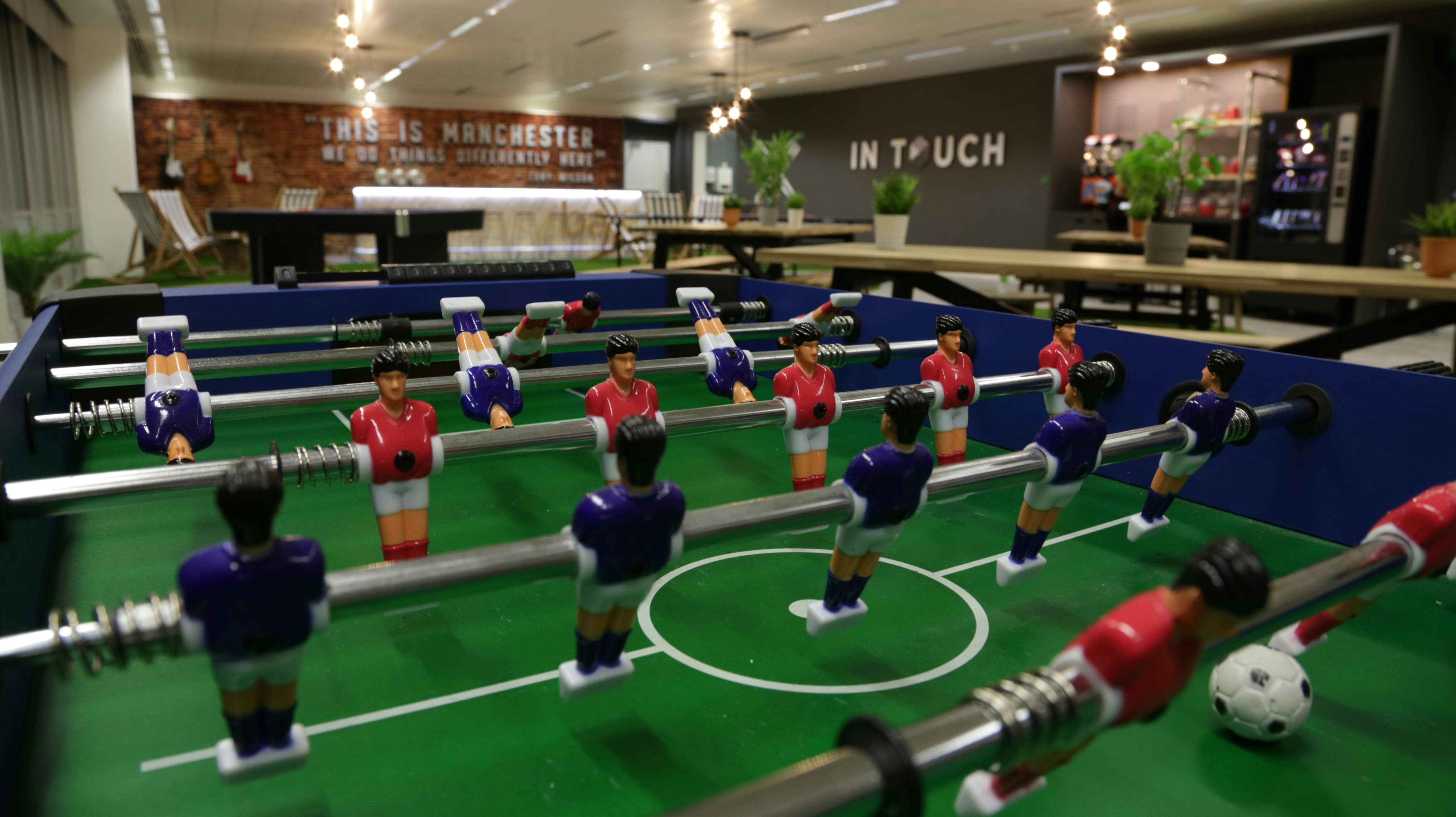 Vibrant foosball table in modern meeting space for corporate events and team-building.