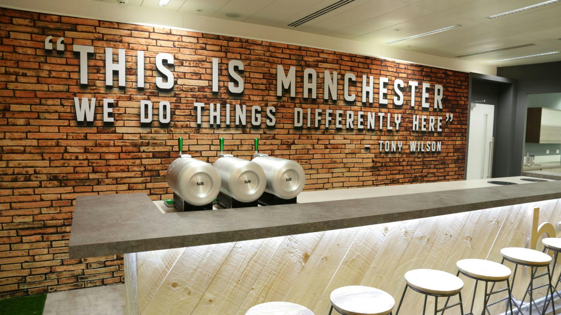 Modern event space at The Lawn Club, featuring a brick wall and local culture.