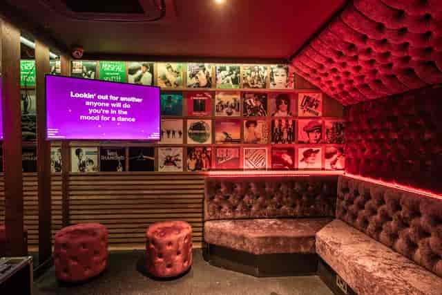 Private karaoke room with plush seating for intimate parties and events at Lucky Voice Holborn.