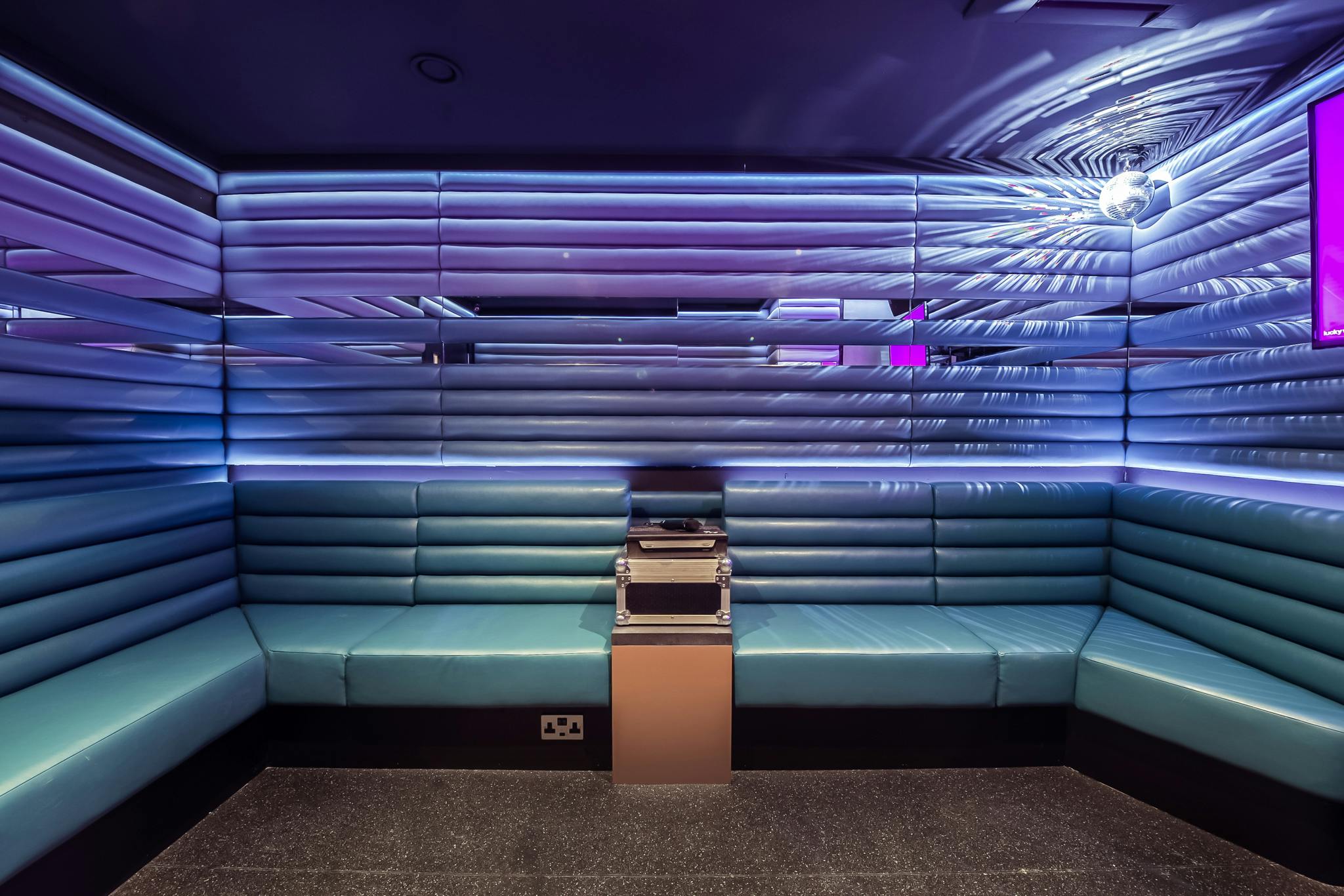 Private karaoke room with sleek seating for creative meetings and events in Holborn.