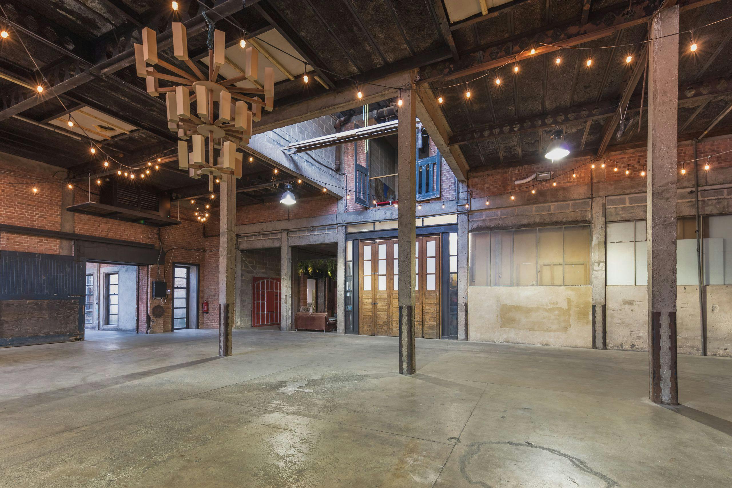 Versatile event space in Hoxton Docks with exposed brick walls, ideal for weddings and conferences.