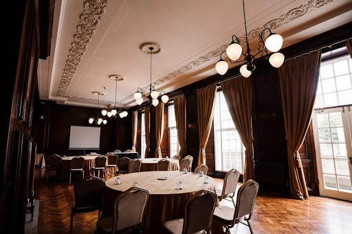 Elegant meeting space in Manchester Hall with natural light, perfect for corporate events.