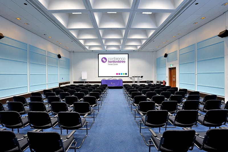 Modern conference room with black chairs, ready for presentations and workshops.