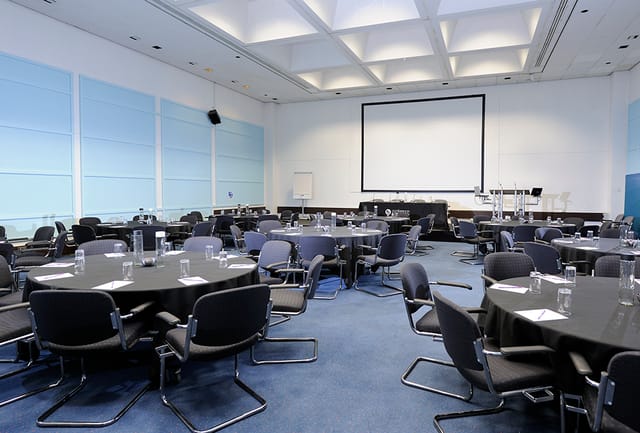 Conference Room in Fielder Centre with round tables, ideal for meetings and presentations.