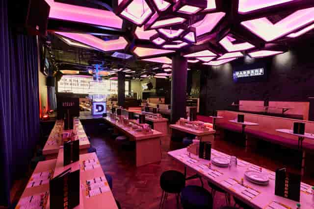 Modern event venue with unique ceiling design, perfect for gatherings and meetings.