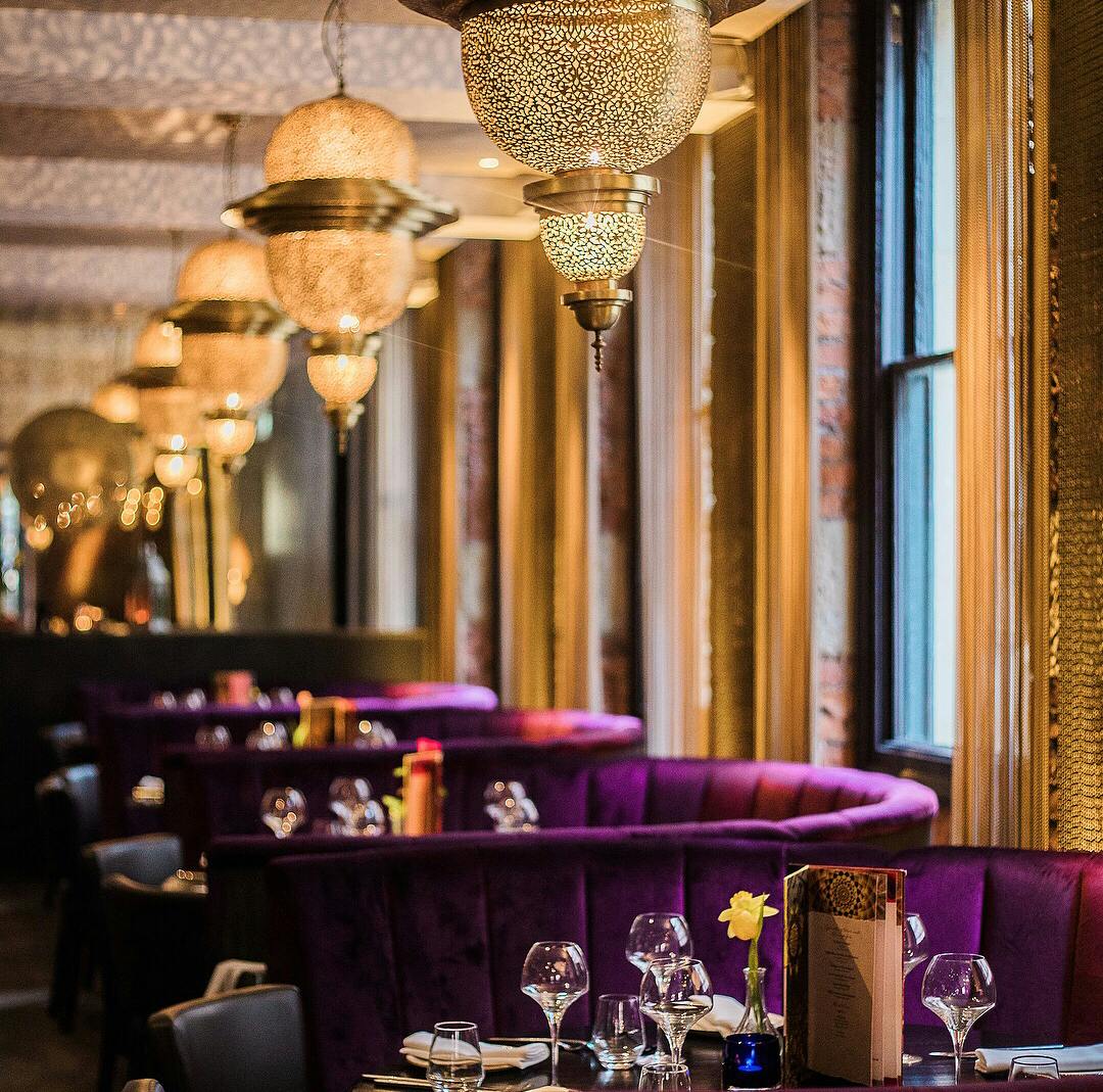 Stylish event space with plush purple seating in Asha's Manchester for upscale gatherings.