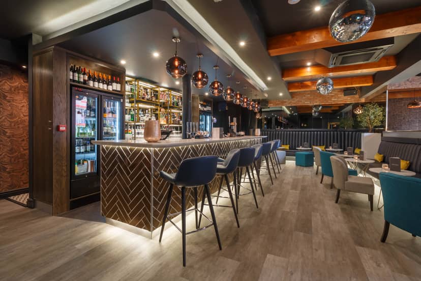 Modern Velvet Bar with ambient lighting, perfect for networking events and gatherings.