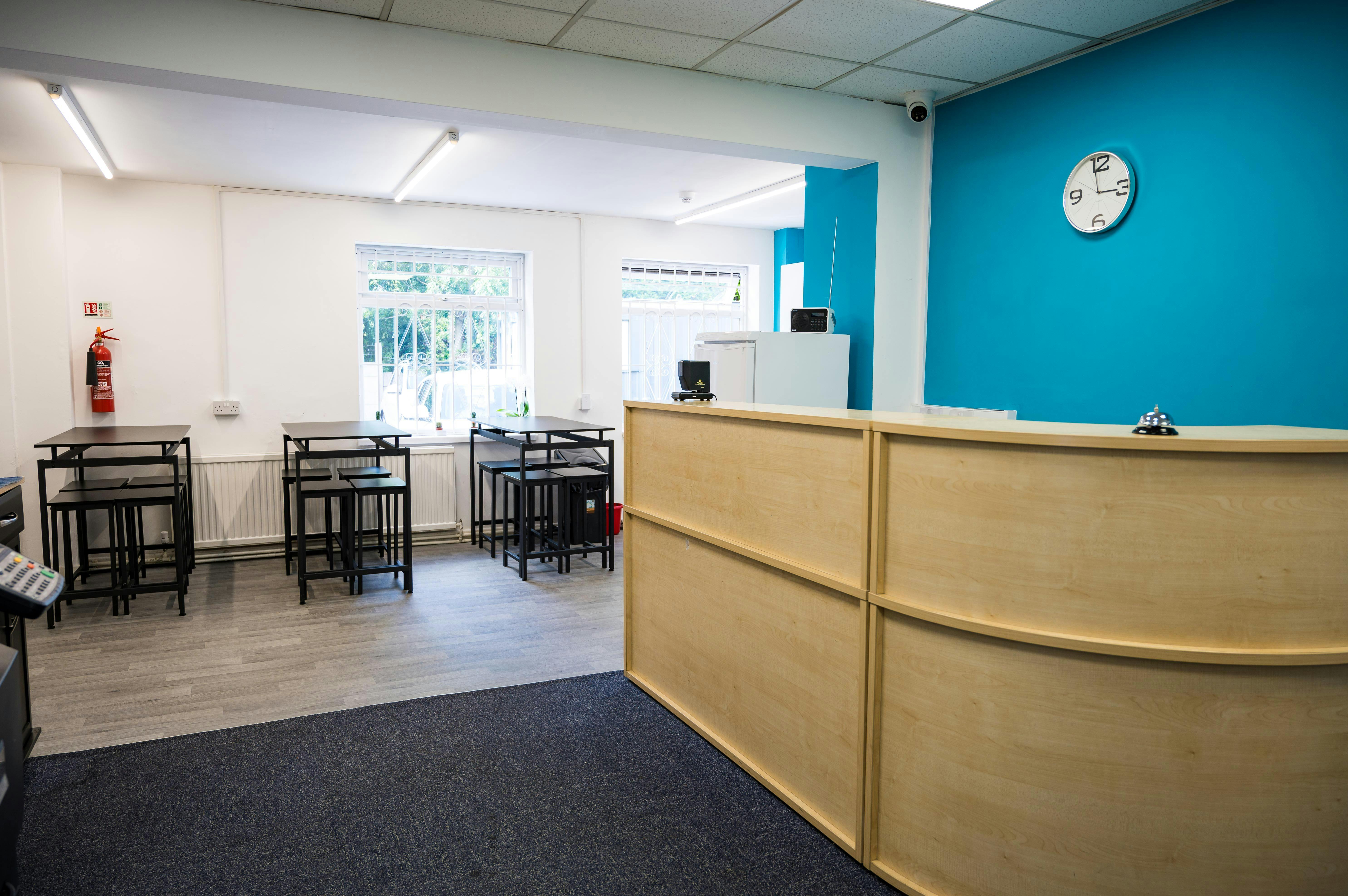 Modern training room with blue accent wall for meetings and events in Salford.