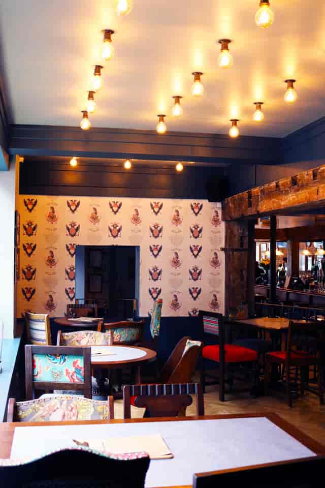 Stylish venue with vintage lighting, perfect for networking events and gatherings.