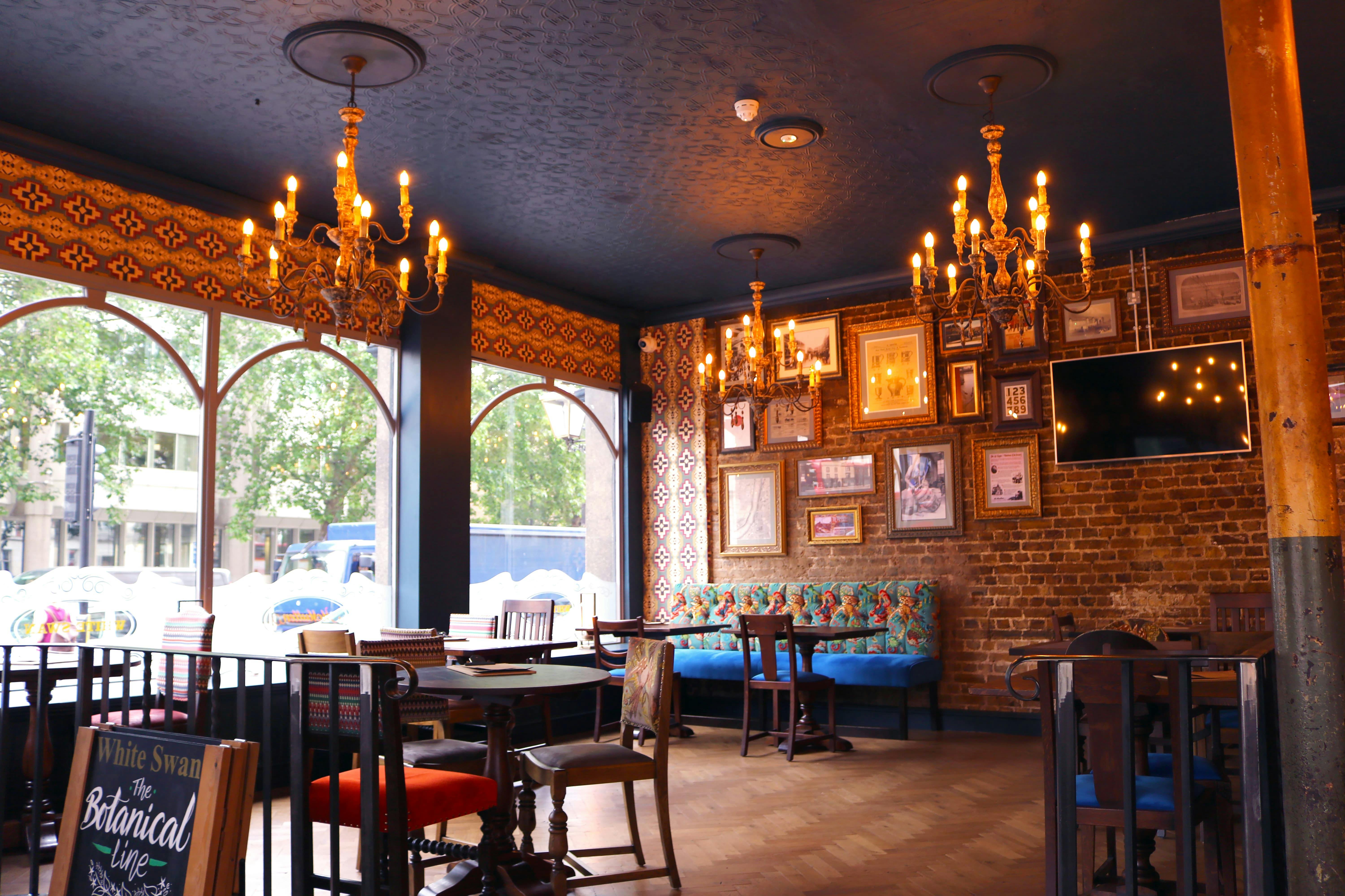 Stylish Pimlico Corner venue with elegant chandeliers, perfect for gatherings and meetings.