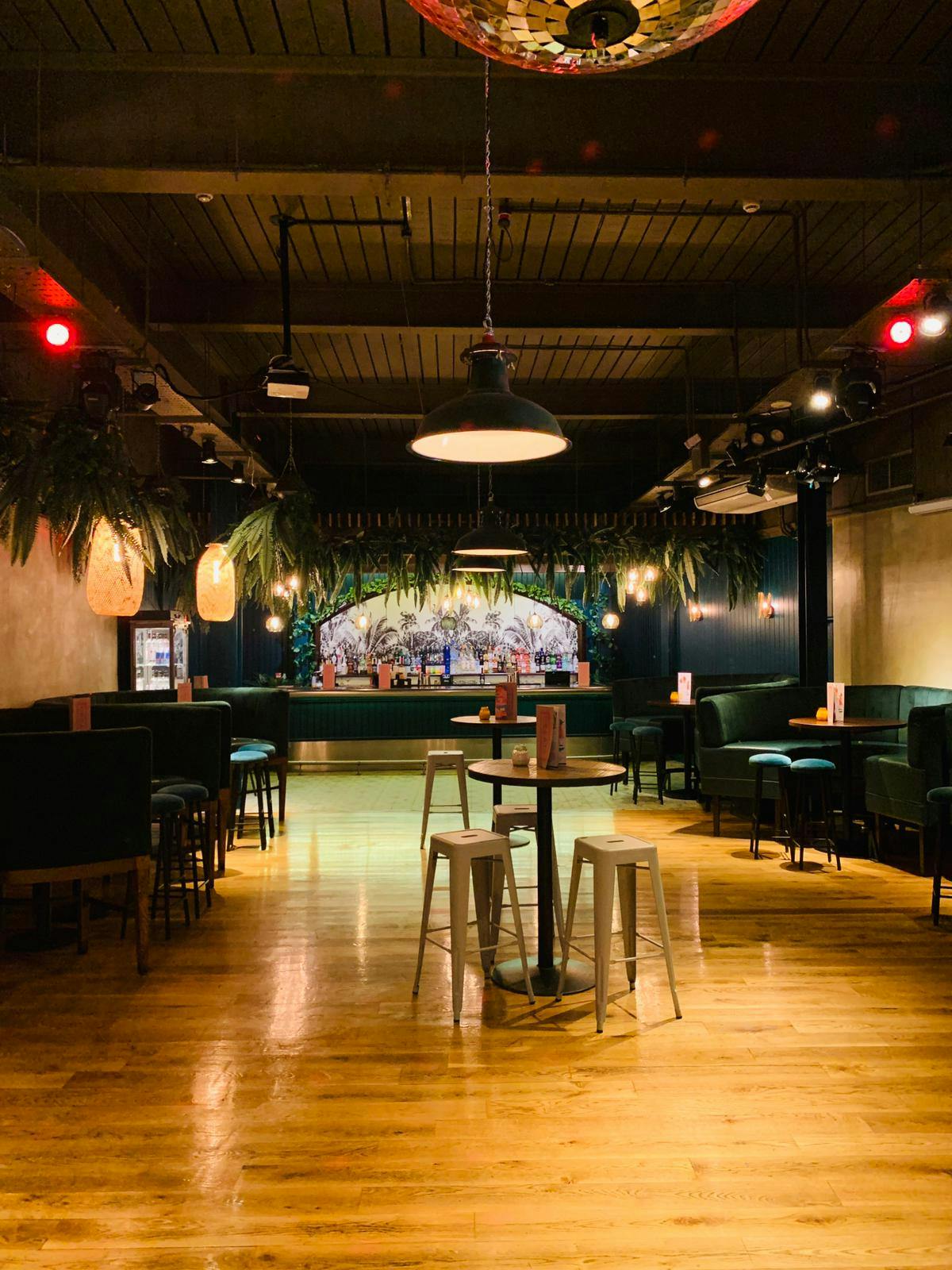 Stylish event space in Revolution Cardiff with vibrant bar and modern decor for gatherings.
