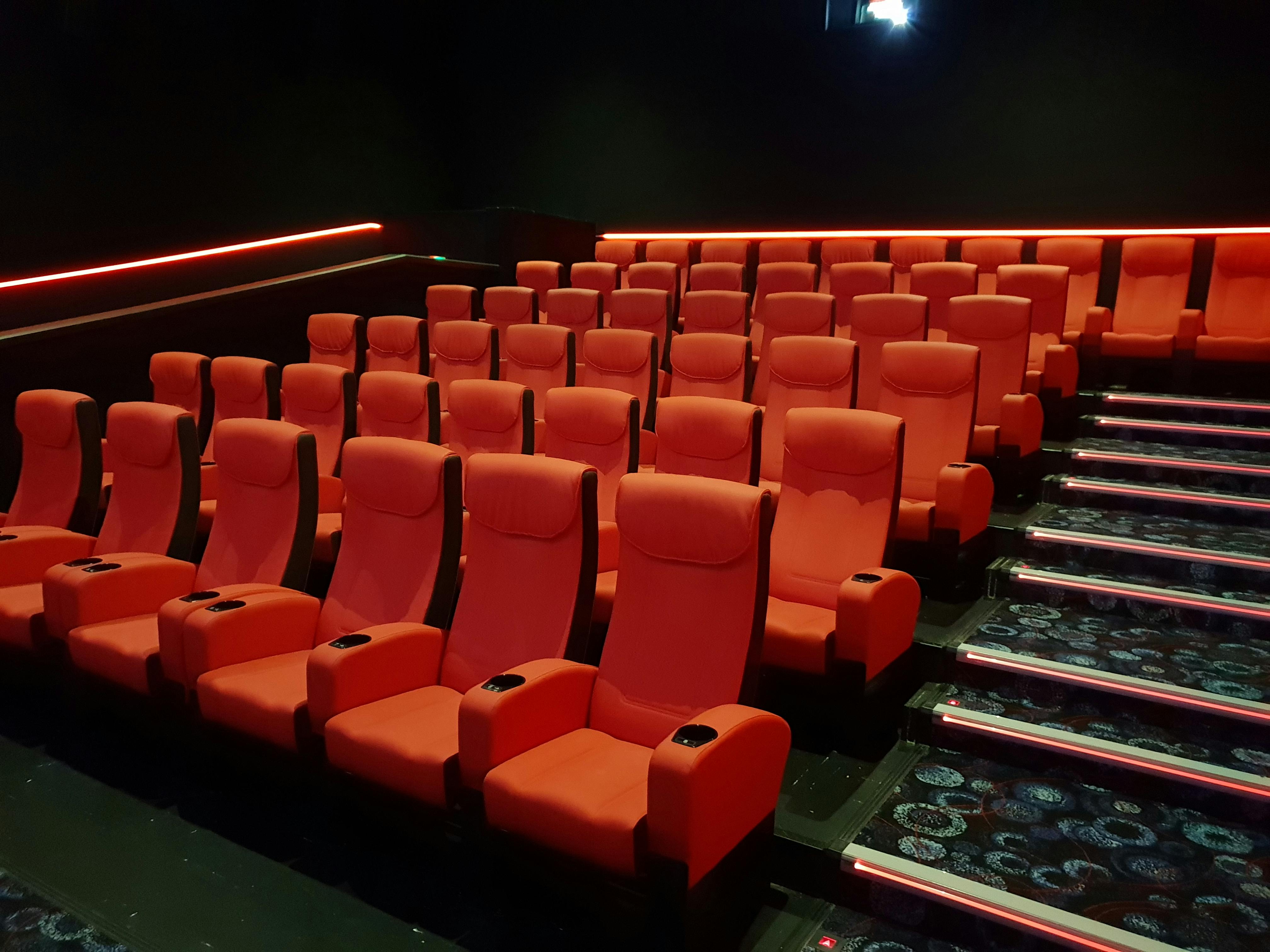 Modern theater seating in Cineworld Watford with vibrant red chairs for film screenings.