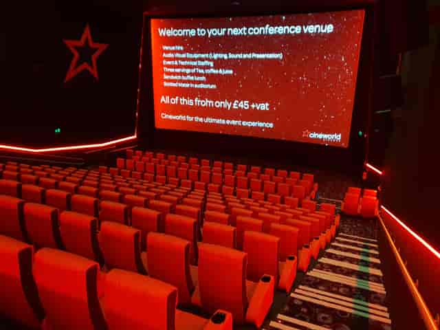 Cineworld Watford conference setup with red seating and dynamic lighting for events.