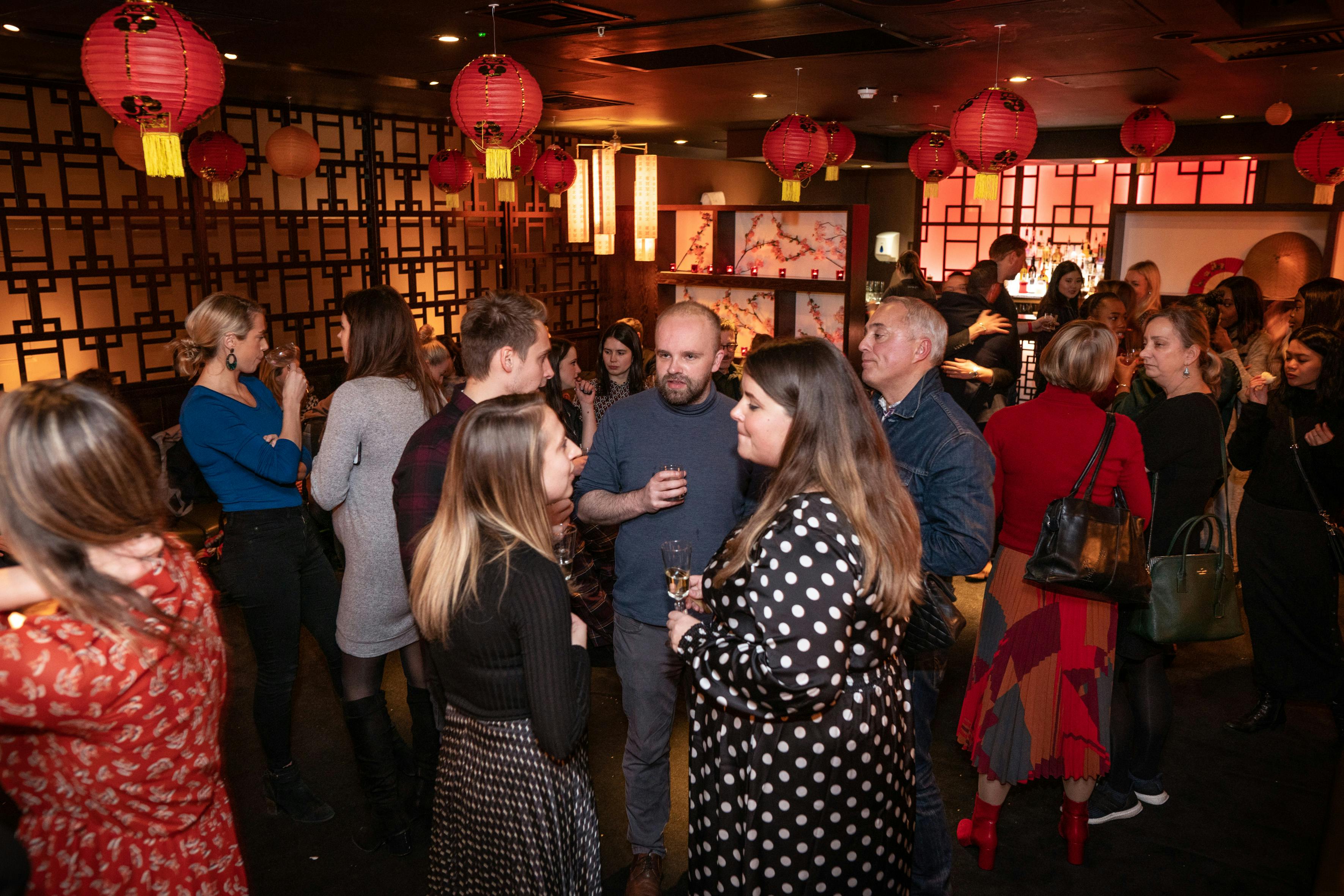 Vibrant networking event at Ping Pong Southbank bar with warm lighting and lanterns.