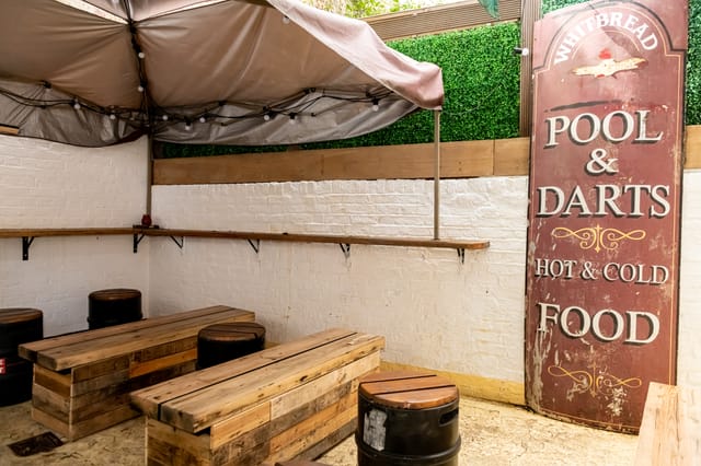 Cozy rustic event space with wooden seating for casual gatherings and team-building activities.